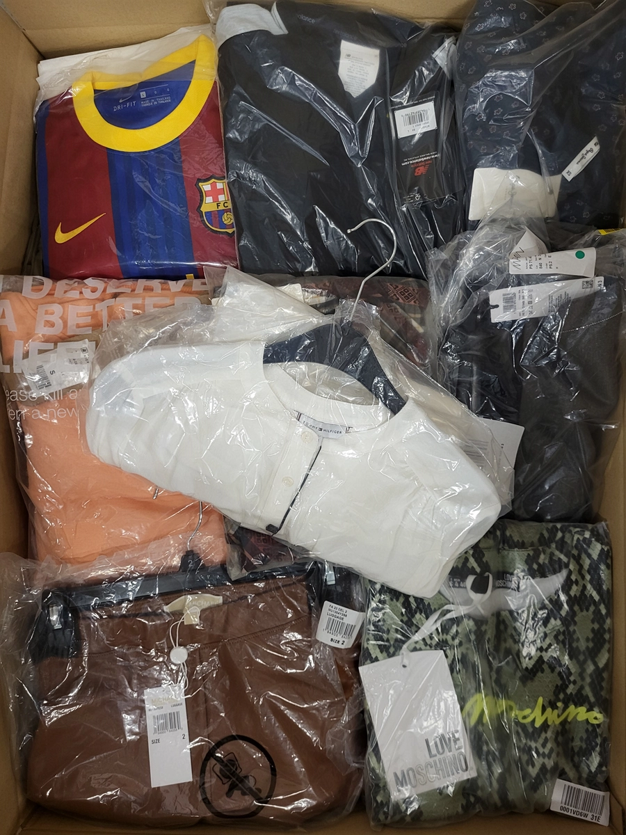 The photo shows a package with clothing in the category AW.