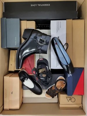 The photo shows a package with footwear in the category AS.