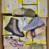 The photo shows a package with footwear in the category SM.