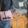The photo shows a package with clothing in the category AJS.