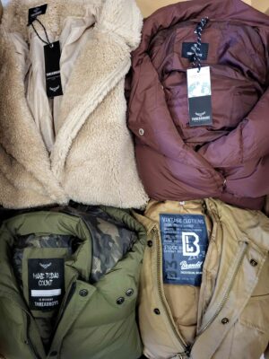 The photo shows a package with clothing in the category TJ.