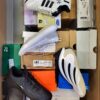 The photo shows a package with footwear in the category CS.