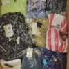 The photo shows a package with clothing in the category AW.