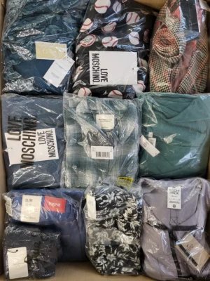 The photo shows a package with clothing in the category AW.