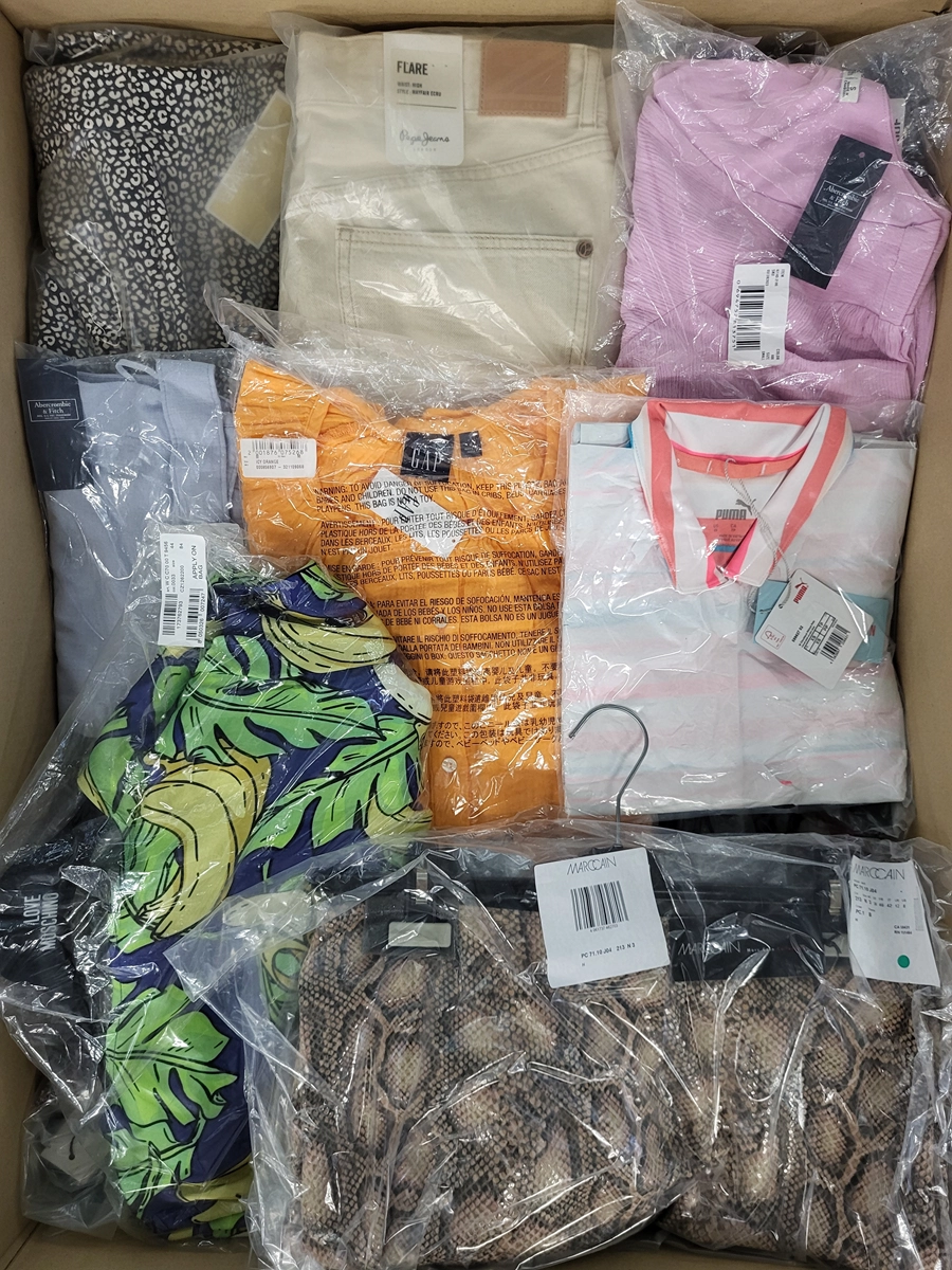 The photo shows a package with clothing in the category AW.