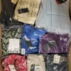 The photo shows a package with clothing in the category AW.