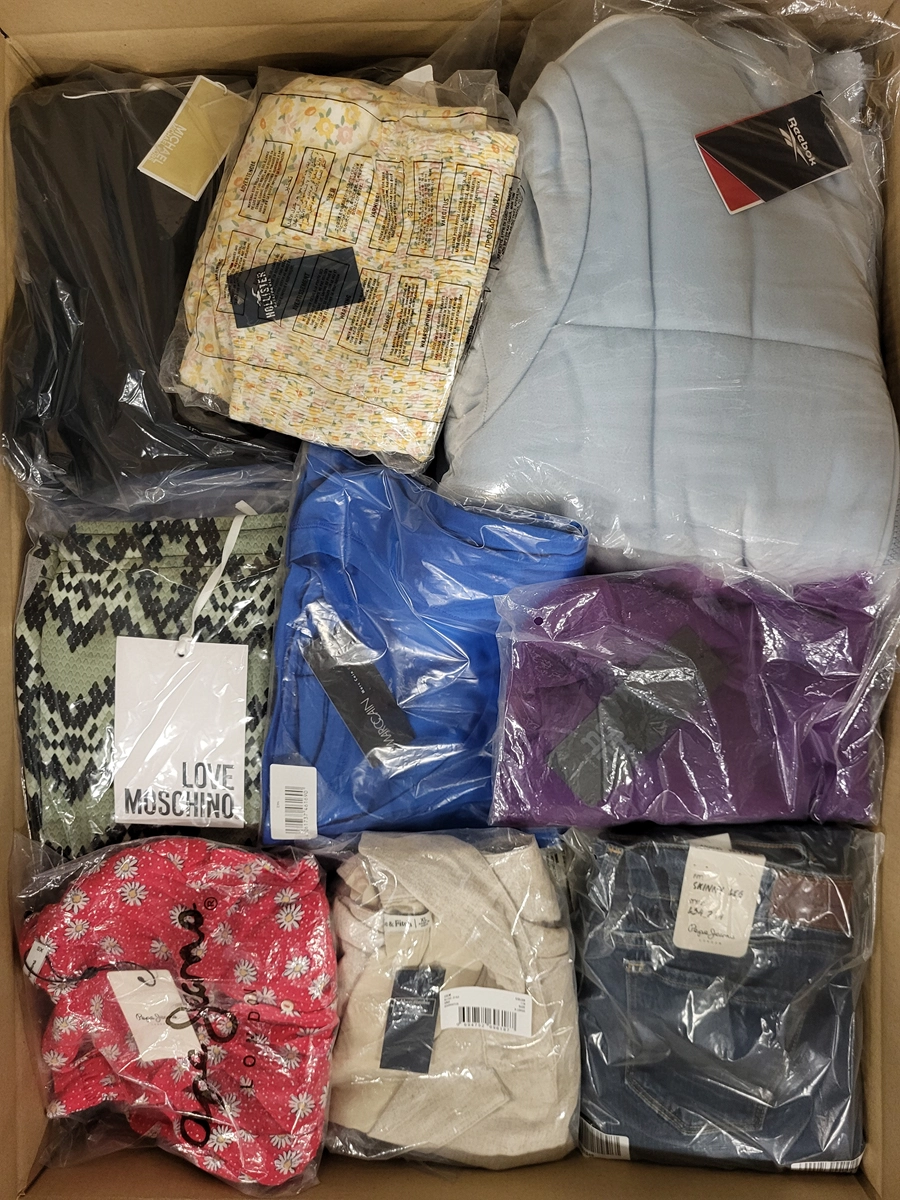 The photo shows a package with clothing in the category AW.