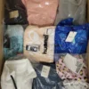The photo shows a package with clothing in the category AW.