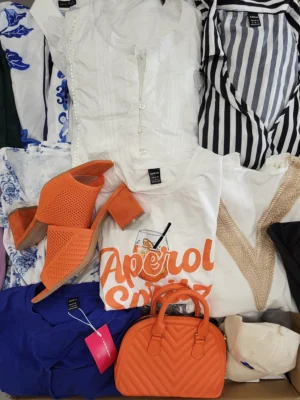 The photo shows a package with clothing in the category SN.