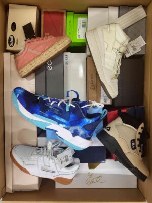 The photo shows a package with footwear in the category AS.