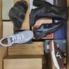 The photo shows a package with footwear in the category AS.