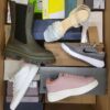 The photo shows a package with footwear in the category AS.