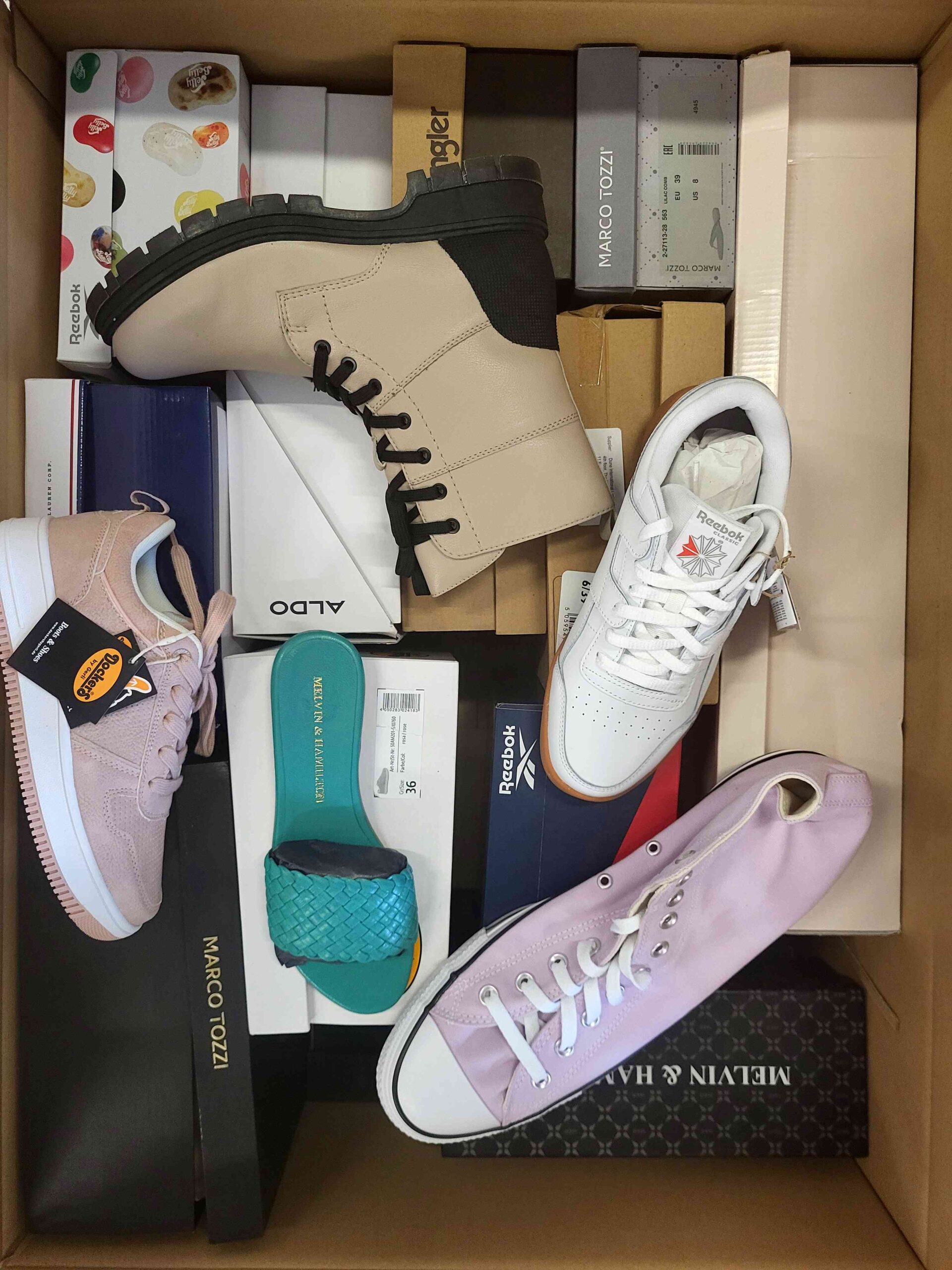 The photo shows a package with footwear in the category AS.