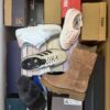The photo shows a package with footwear in the category AS.