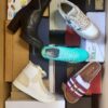 The photo shows a package with footwear in the category AS.