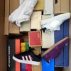 The photo shows a package with footwear in the category BS.
