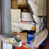 The photo shows a package with footwear in the category BS.