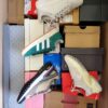 The photo shows a package with footwear in the category BS.