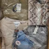 The photo shows a package with clothing in the category AJS.