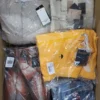 The photo shows a package with clothing in the category AJS.