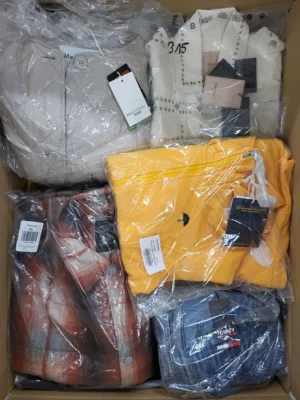The photo shows a package with clothing in the category AJS.