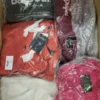 The photo shows a package with clothing in the category AJS.