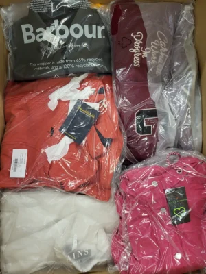 The photo shows a package with clothing in the category AJS.