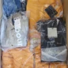 The photo shows a package with clothing in the category AJS.