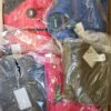 The photo shows a package with clothing in the category AJS.
