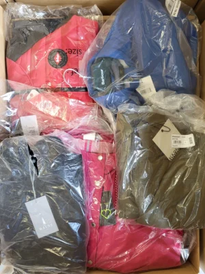 The photo shows a package with clothing in the category AJS.