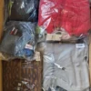 The photo shows a package with clothing in the category AJS.
