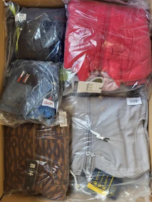 The photo shows a package with clothing in the category AJS.