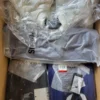 The photo shows a package with clothing in the category AJS.