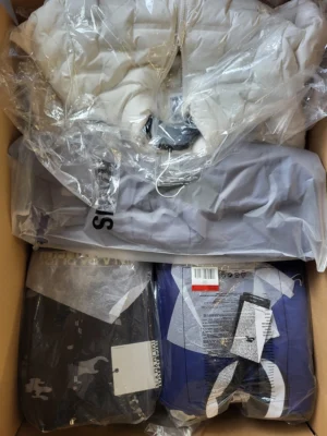 The photo shows a package with clothing in the category AJS.
