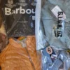 The photo shows a package with clothing in the category AJS.