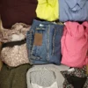 The photo shows a package with clothing in the category TSC.