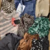 The photo shows a package with clothing in the category TSC.
