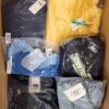 The photo shows a package with clothing in the category AJS.