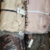 The photo shows a package with clothing in the category AJW.