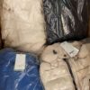 The photo shows a package with clothing in the category AJW.