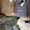 The photo shows a package with clothing in the category AJW.