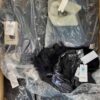The photo shows a package with clothing in the category AJW.