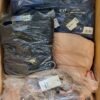 The photo shows a package with clothing in the category AJW.