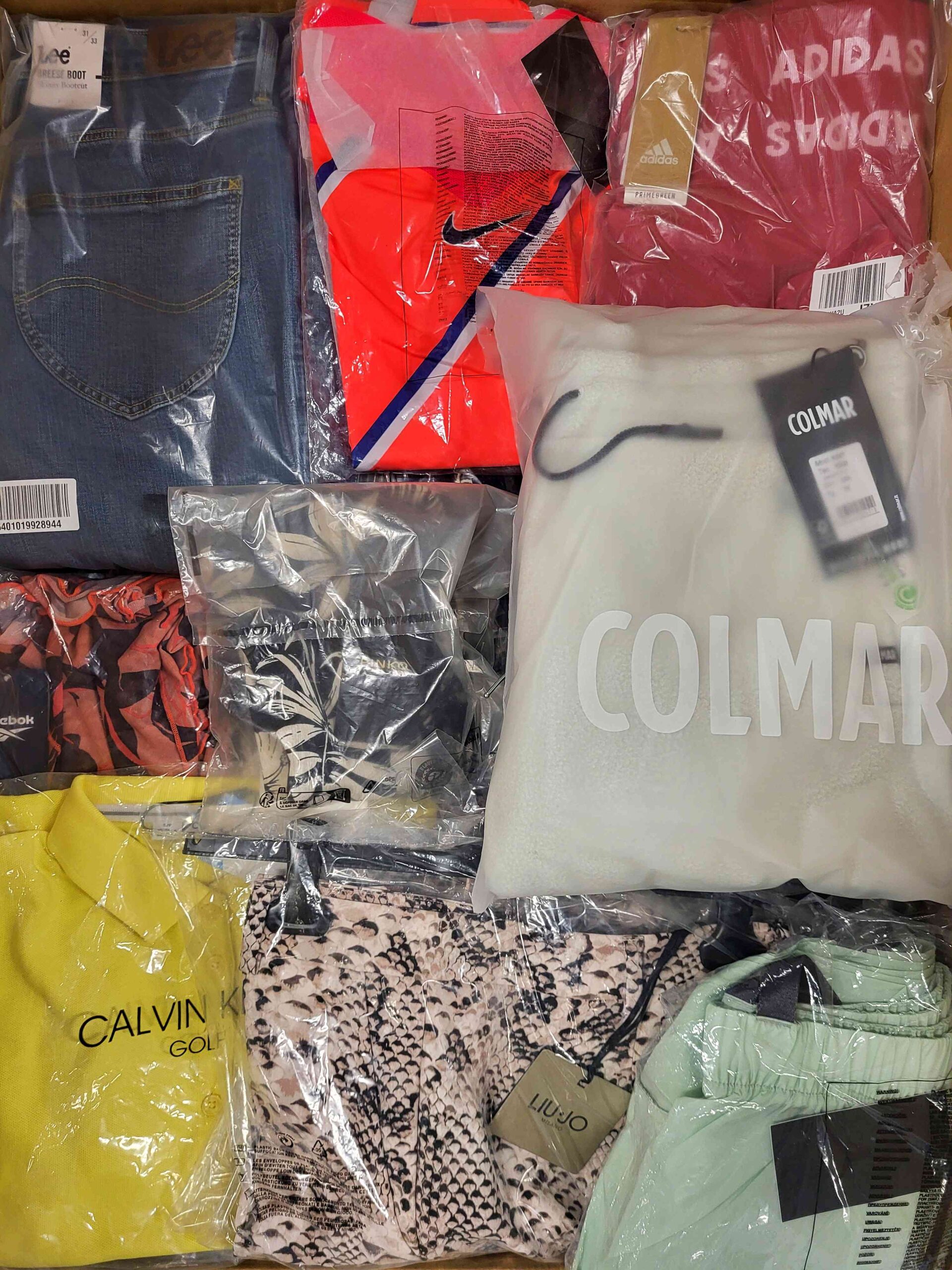 The photo shows a package with clothing in the category AW.