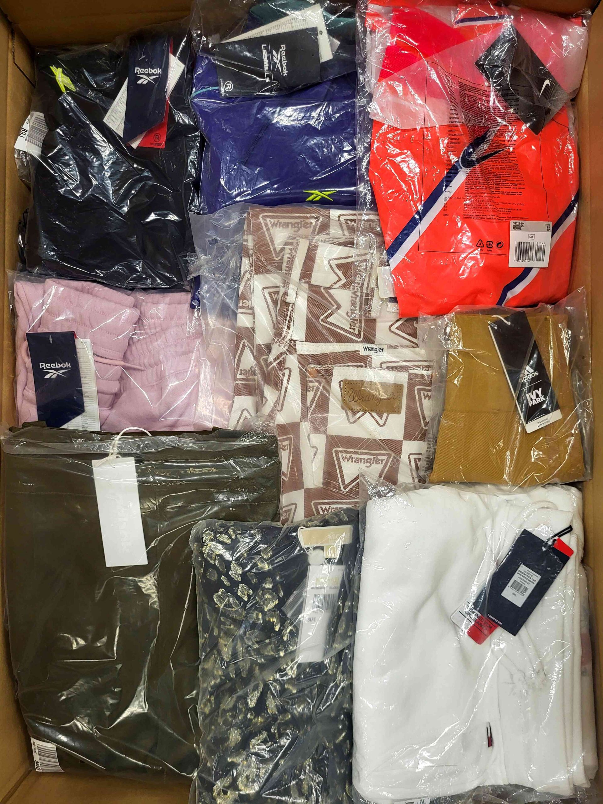 The photo shows a package with clothing in the category AW.
