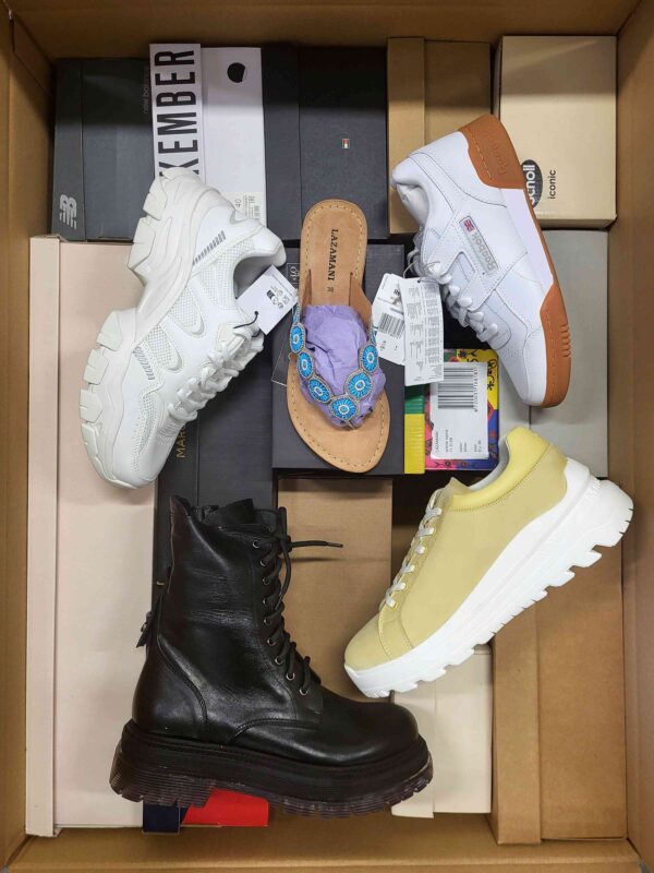 The photo shows a package with footwear in the category AS.