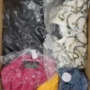 The photo shows a package with clothing in the category AJS.
