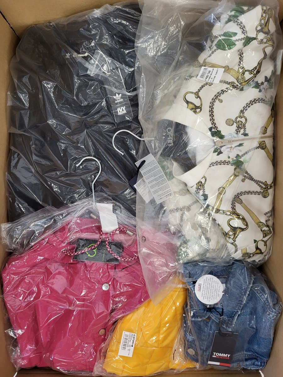 The photo shows a package with clothing in the category AJS.