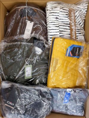 The photo shows a package with clothing in the category AJS.