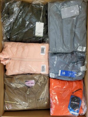The photo shows a package with clothing in the category AJS.